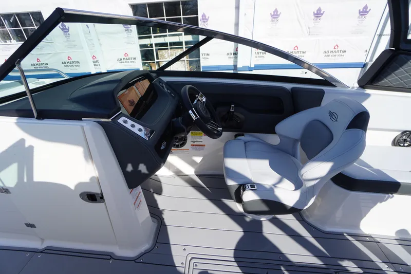 Slide: The Image of 2026 Chaparral 250 OSX boat interior with modern helm and comfortable seating. - 16