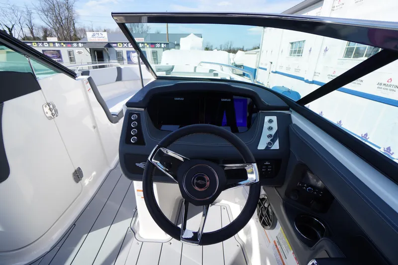 Slide: The Image of 2026 Chaparral 250 OSX boat cockpit with modern steering and dashboard controls. - 17