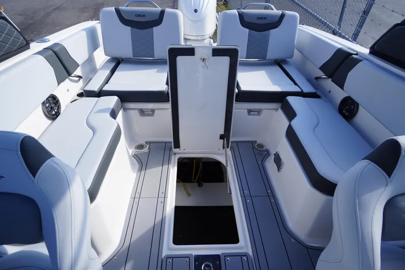 Slide: The Image of 2026 Chaparral 250 OSX boat interior with spacious seating and storage compartments. - 33