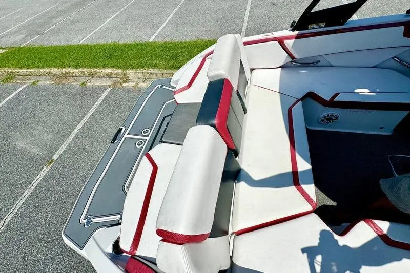 Slide: The Image of 2015 Scarab 215 HO Impulse boat interior with red and white seating. - 11