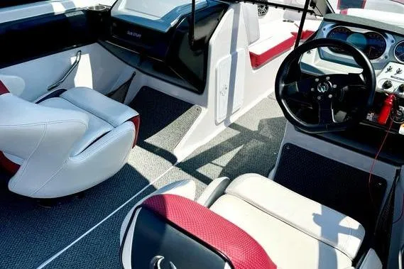 Slide: The Image of 2015 Scarab 215 HO Impulse boat interior with modern dashboard and seating. - 16