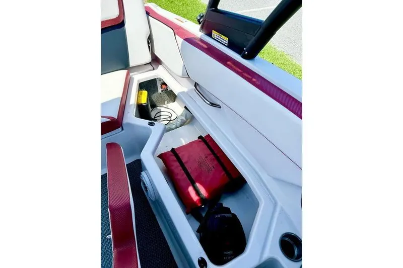 Slide: The Image of 2015 Scarab 215 HO Impulse boat interior storage with safety equipment and accessories. - 21