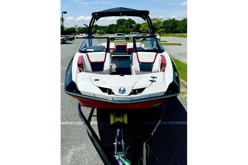 Slide: The Image of 2015 Scarab 215 HO Impulse boat with sleek design in a parking lot. - 5