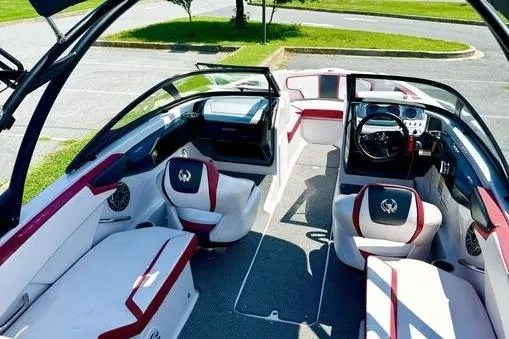 Slide: The Image of 2015 Scarab 215 HO Impulse boat interior with red and white seating, steering wheel, and dashboard. - 9