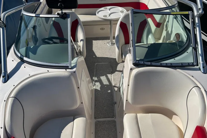 Slide: The Image of 2004 Rinker 212 Captiva Bowrider interior with seating and windshield. - 10