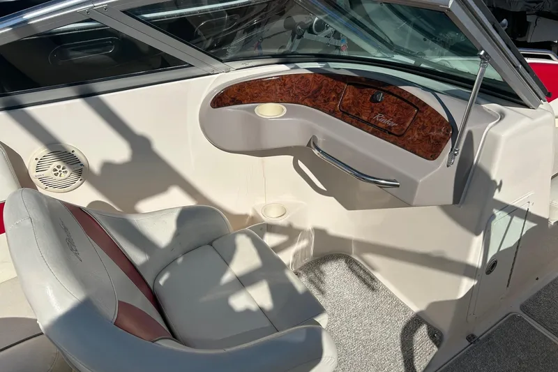 Slide: The Image of 2004 Rinker 212 Captiva Bowrider interior with seating and dashboard details. - 12