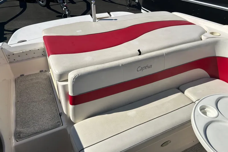Slide: The Image of 2004 Rinker 212 Captiva Bowrider boat interior with red and white seating. - 14