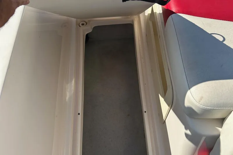 Slide: The Image of 2004 Rinker 212 Captiva Bowrider interior storage compartment with seating. - 17