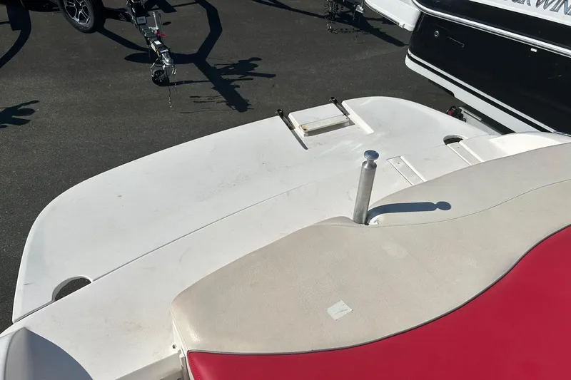 Slide: The Image of 2004 Rinker 212 Captiva Bowrider boat deck with red and beige seating. - 18