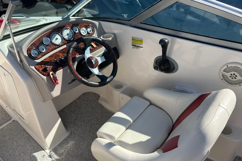 Slide: The Image of 2004 Rinker 212 Captiva Bowrider dashboard with steering wheel and gauges. - 8