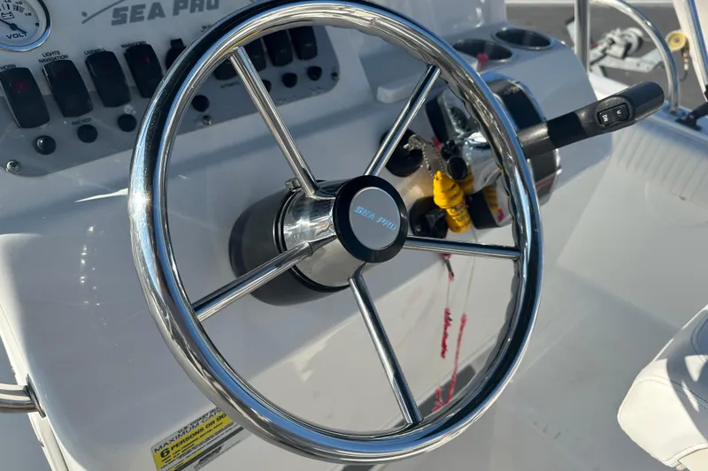 Slide: The Image of Steering wheel of 2008 Sea Pro 186 Center Console boat, featuring control panel and throttle. - 10