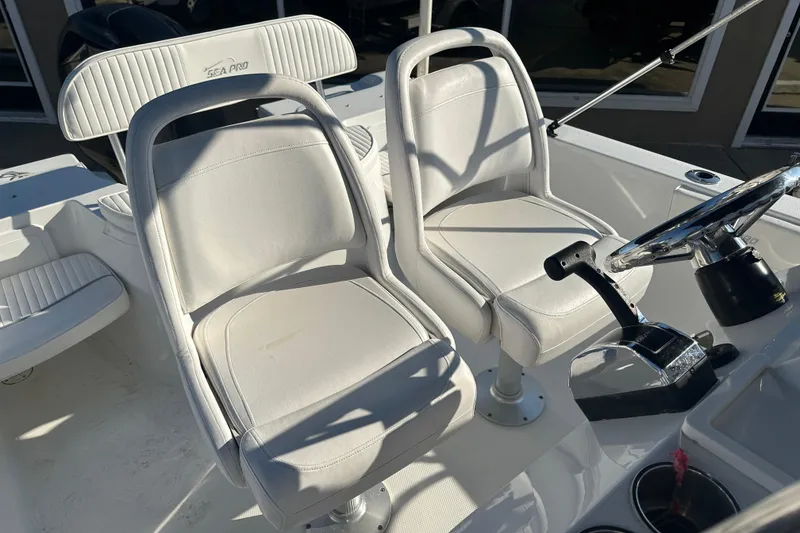 Slide: The Image of 2008 Sea Pro 186 Center Console boat interior with white seating and steering wheel. - 12