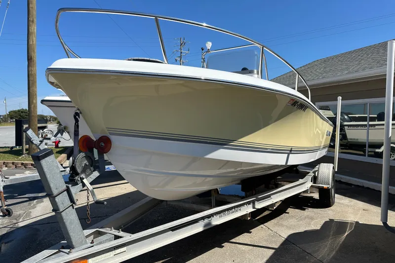 Slide: The Image of 2008 Sea Pro 186 Center Console boat on trailer, parked outdoors under clear blue sky. - 2
