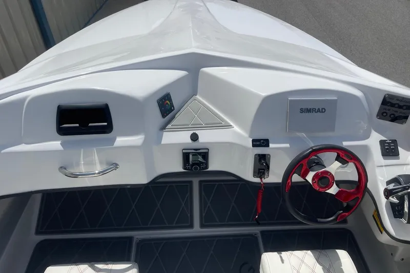 Slide: The Image of 2026 Lightning Boat Works Strike 200 dashboard with red steering wheel and Simrad display. - 11