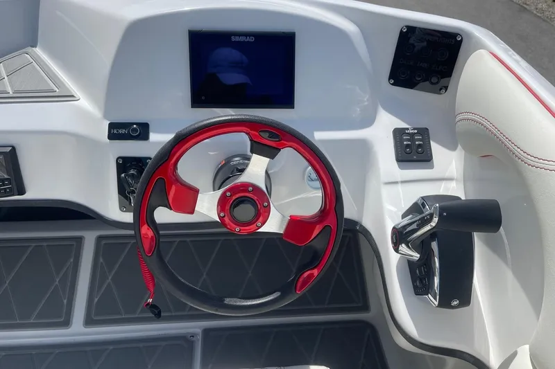 Slide: The Image of Steering console of 2026 Lightning Boat Works Strike 200 with red accents and modern controls. - 13