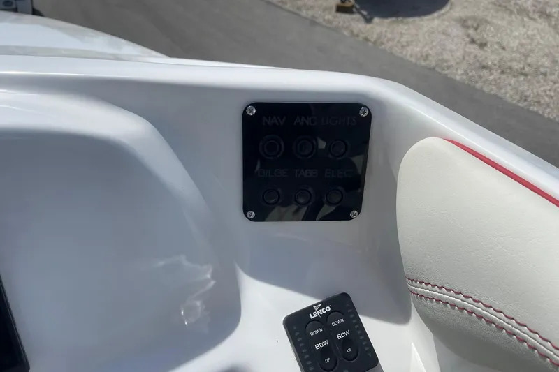 Slide: The Image of Control panel of 2026 Lightning Boat Works Strike 200 with navigation and light switches. - 14