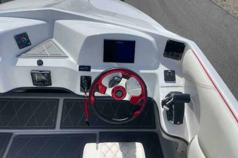 Slide: The Image of 2026 Lightning Boat Works Strike 200 dashboard with red steering wheel and modern controls. - 25