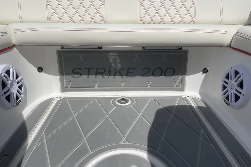 Slide: The Image of 2026 Lightning Boat Works Strike 200 interior with speakers and cushioned seating. - 27