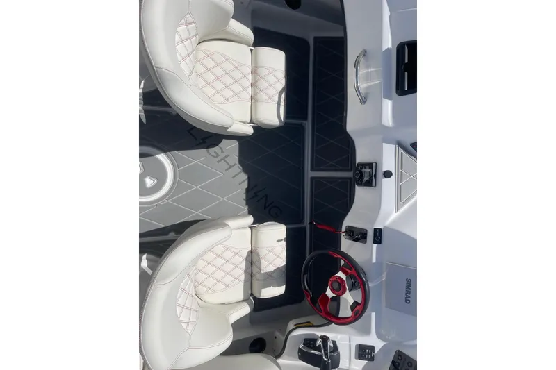 Slide: The Image of Interior of 2026 Lightning Boat Works Strike 200, featuring white seats and modern controls. - 9