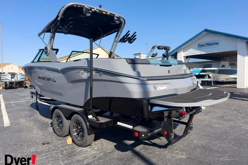 Slide: The Image of 2026 MasterCraft NXT23 boat on trailer at Dyer Marine dealership. - 1