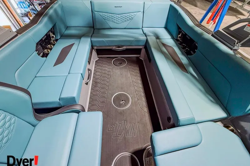Slide: The Image of 2026 MasterCraft NXT23 boat interior with blue seating and modern design. - 11