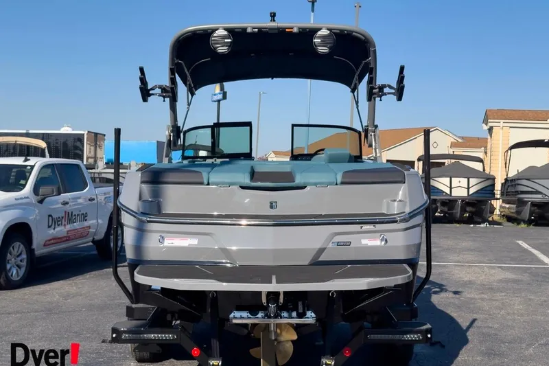 Slide: The Image of 2026 MasterCraft NXT23 boat displayed at Dyer Marine dealership. - 2