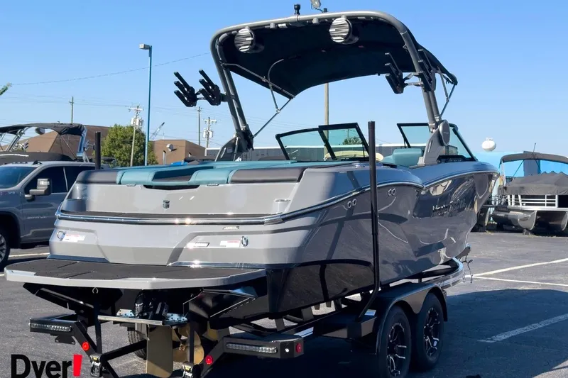 Slide: The Image of 2026 MasterCraft NXT23 boat on trailer in parking lot, rear view. - 3