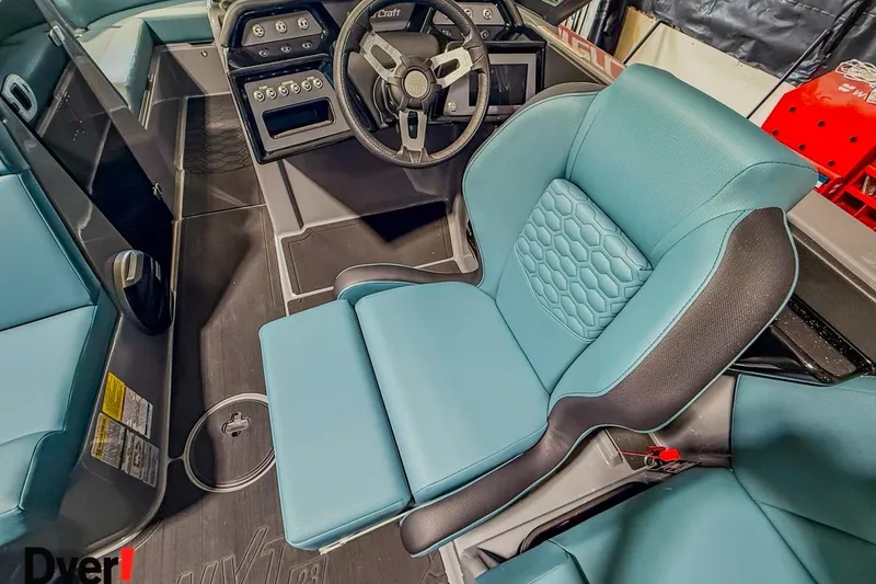 Slide: The Image of 2026 MasterCraft NXT23 boat interior with modern steering wheel and blue seating. - 7