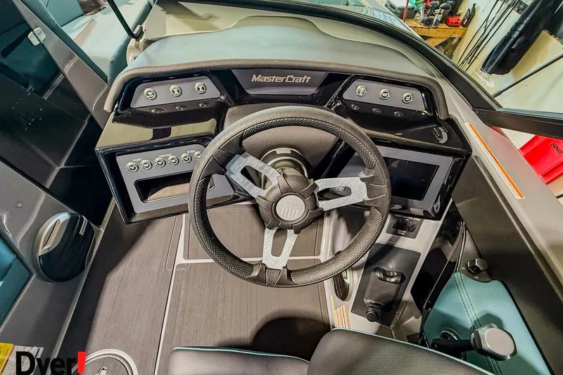 Slide: The Image of Interior view of 2026 MasterCraft NXT23 boat dashboard with steering wheel and controls. - 8