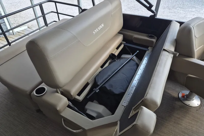 Slide: The Image of 2026 Sylvan Mirage 820 CLZ DH boat interior with open storage compartment. - 12