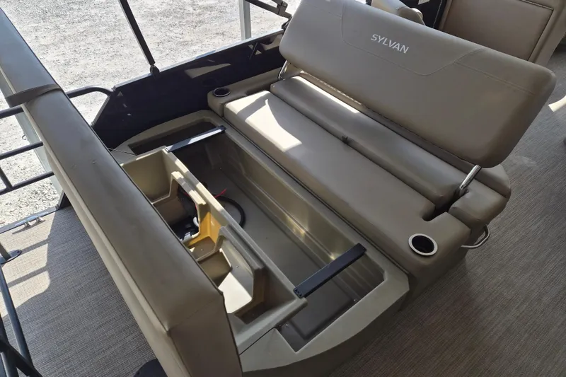 Slide: The Image of 2026 Sylvan Mirage 820 CLZ DH boat interior with storage compartment and seating. - 14
