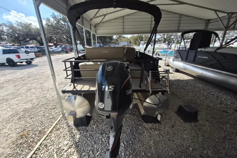 Slide: The Image of 2026 Sylvan Mirage 820 CLZ DH pontoon boat with Yamaha 115 engine, parked under a canopy. - 4