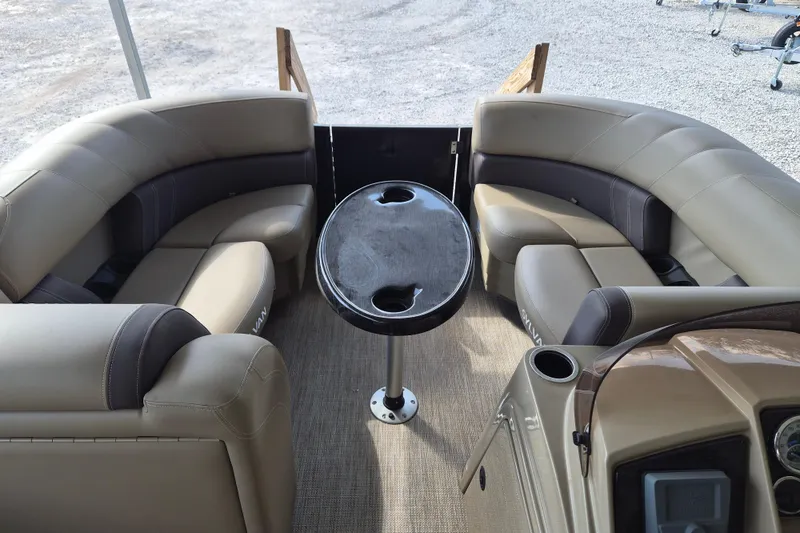 Slide: The Image of 2026 Sylvan Mirage 820 CLZ DH pontoon boat interior with beige seating and central table. - 5