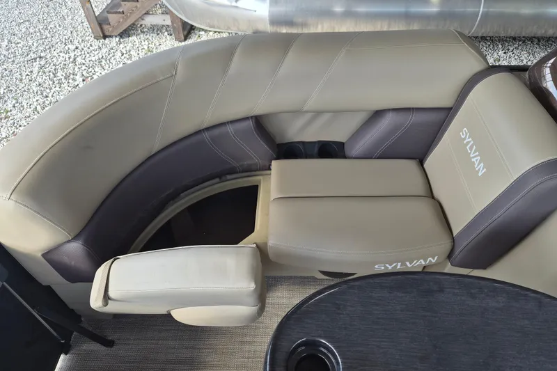 Slide: The Image of Luxurious seating on 2026 Sylvan Mirage 820 CLZ DH pontoon boat, featuring beige and brown upholstery. - 6