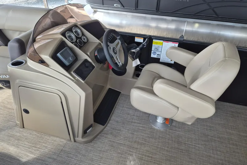 Slide: The Image of 2026 Sylvan Mirage 820 CLZ DH boat helm with beige captain's chair and control panel. - 8