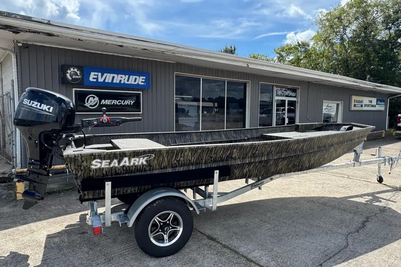 Slide: The Image of 2026 SeaArk 1652 Special boat with Suzuki motor on trailer outside dealership. - 3