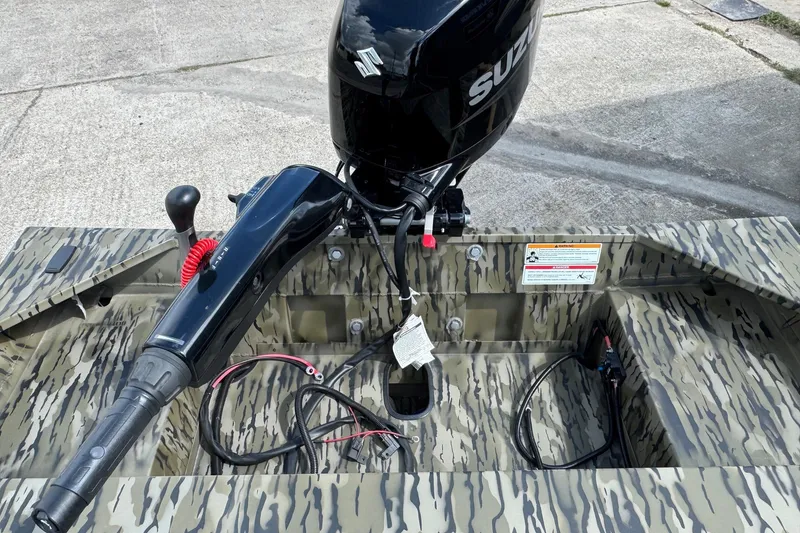 Slide: The Image of 2026 SeaArk 1652 Special boat with Suzuki outboard motor, camo design, and control panel. - 9