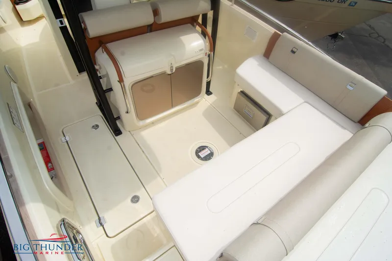Slide: The Image of 2024 Invictus TT280S boat interior with beige seating and storage compartments. - 15