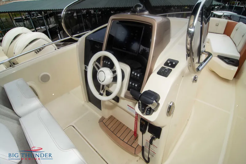 Slide: The Image of 2024 Invictus TT280S boat cockpit with steering wheel and control panel. - 23