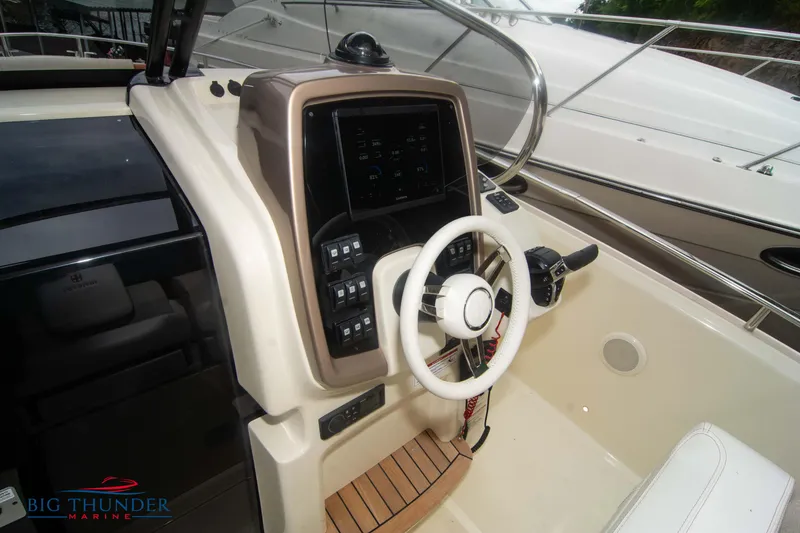 Slide: The Image of 2024 Invictus TT280S boat helm with modern controls and steering wheel. - 24