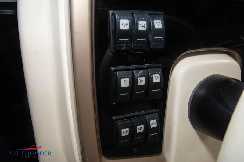 Slide: The Image of Control panel of 2024 Invictus TT280S boat with various switches. - 26