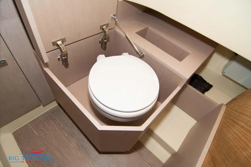Slide: The Image of 2024 Invictus TT280S boat bathroom with modern toilet and wooden cabinetry. - 42