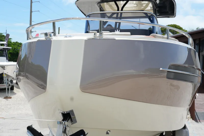 Slide: The Image of 2024 Invictus TT280S boat front view, sleek design, docked outdoors. - 5