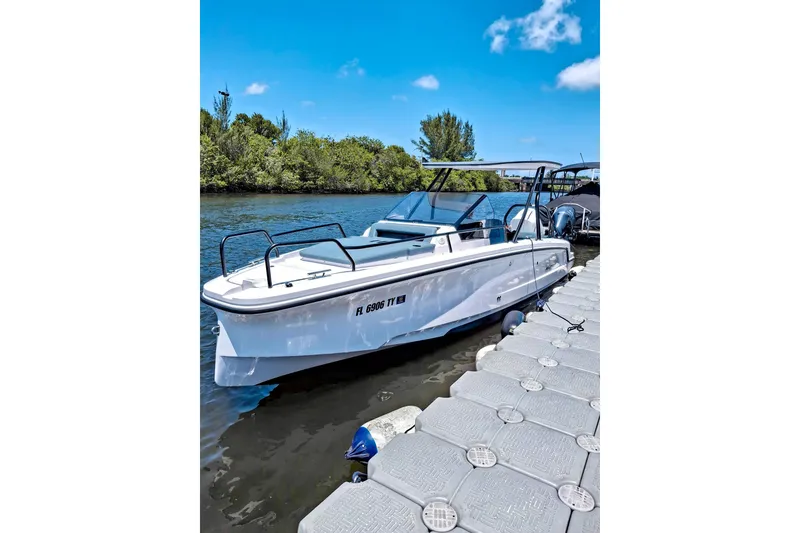 Slide: The Image of 2024 Axopar 25 Cross Top boat docked on a sunny day. - 0