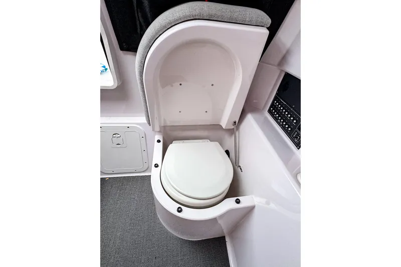 Slide: The Image of 2024 Axopar 25 Cross Top boat interior with compact toilet design. - 10