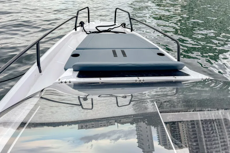 Slide: The Image of 2024 Axopar 25 Cross Top boat on water, featuring sleek design and modern deck layout. - 4