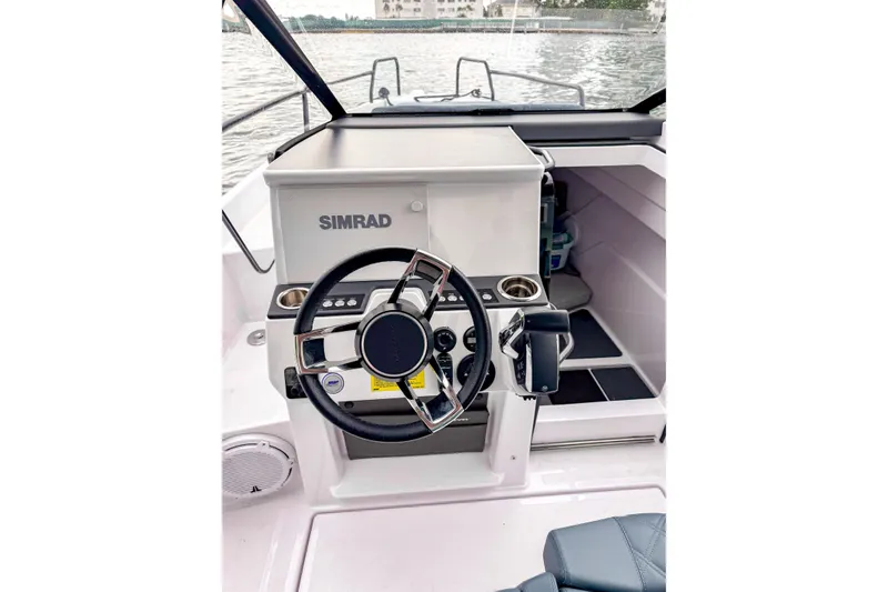 Slide: The Image of 2024 Axopar 25 Cross Top boat helm with Simrad navigation system. - 5