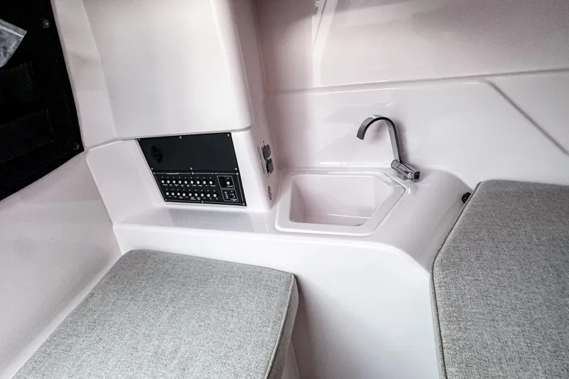 Slide: The Image of Interior of 2024 Axopar 25 Cross Top boat with sink and seating area. - 8