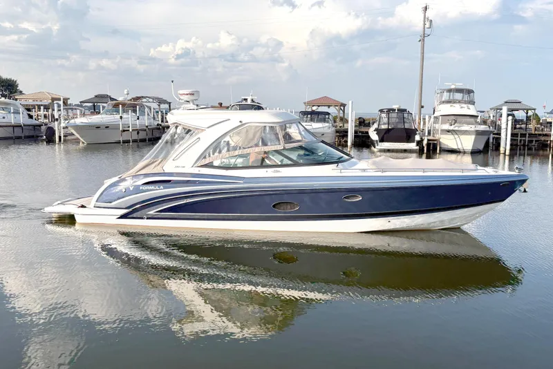 The Image of 2022 Formula 350 Crossover Bowrider I/O in marina, sleek design, calm water reflection. - 0