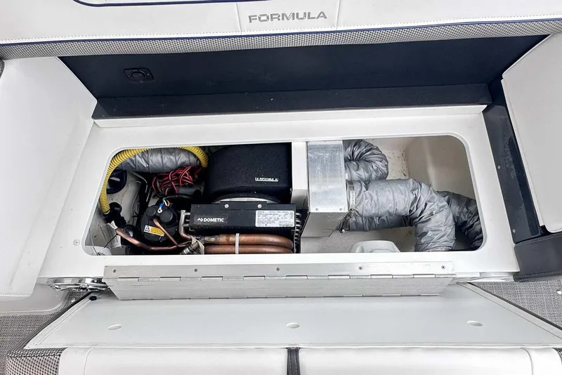 Slide: The Image of 2022 Formula 350 Crossover Bowrider I/O engine compartment with Dometic components and wiring. - 10